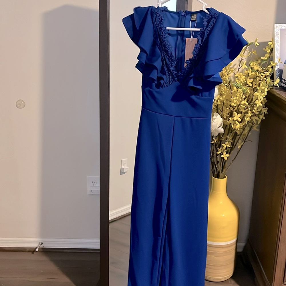 One royal blue jumper no sleeves low cut brand new. Lace pattern around neckline